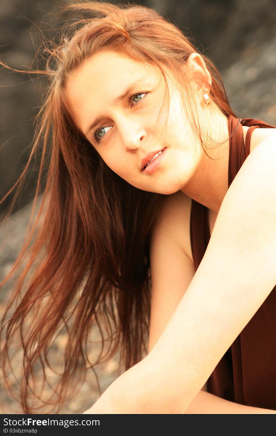 Pretty girl sitting on a background of mountains