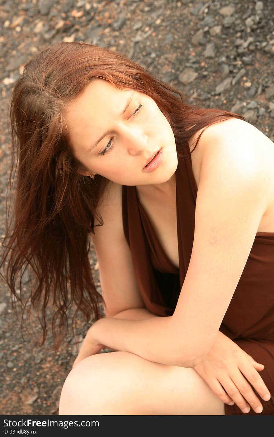 Pretty girl sitting on a background of mountains