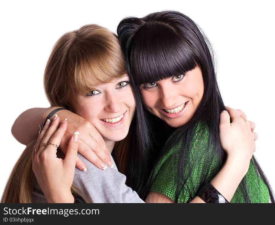 Two smiling girl-friends isolated on the white