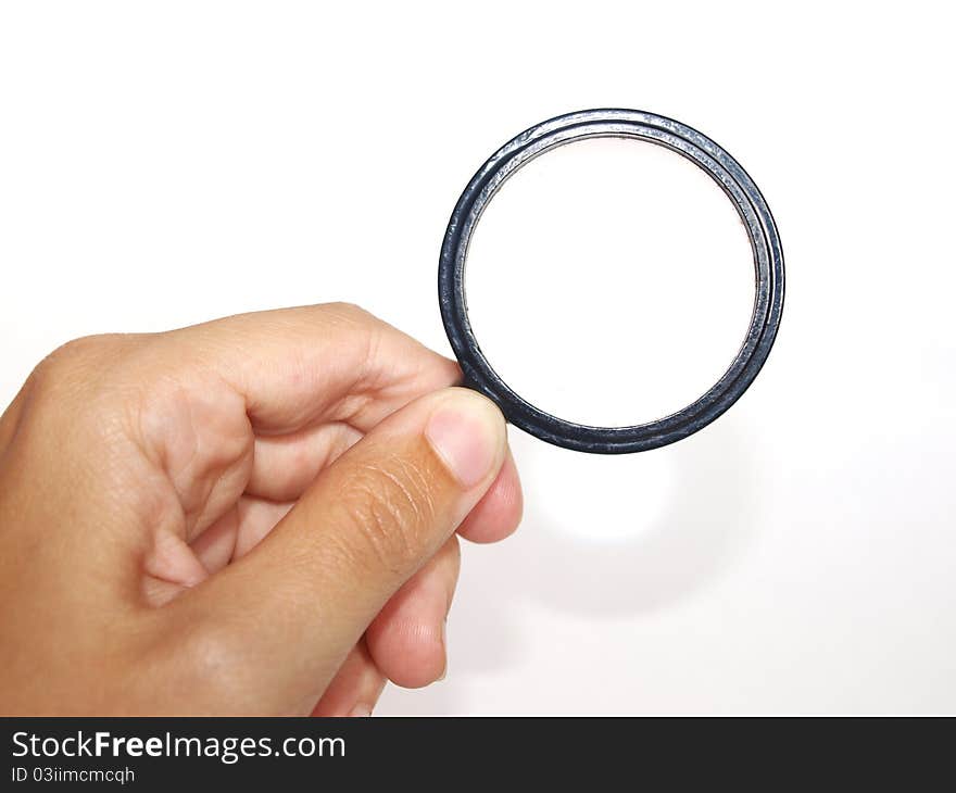 Hand with magnifying glass on a white background