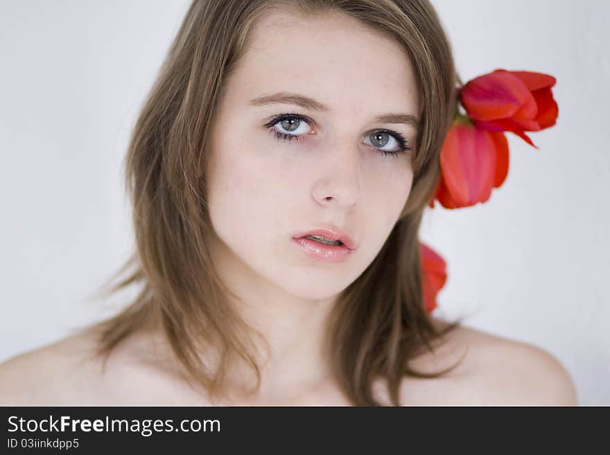 A portrait of a young woman with tulips in her hair