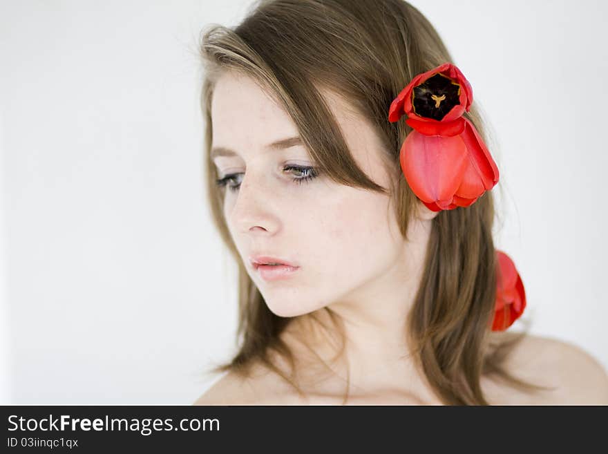 A portrait of a young woman with tulips in her hair