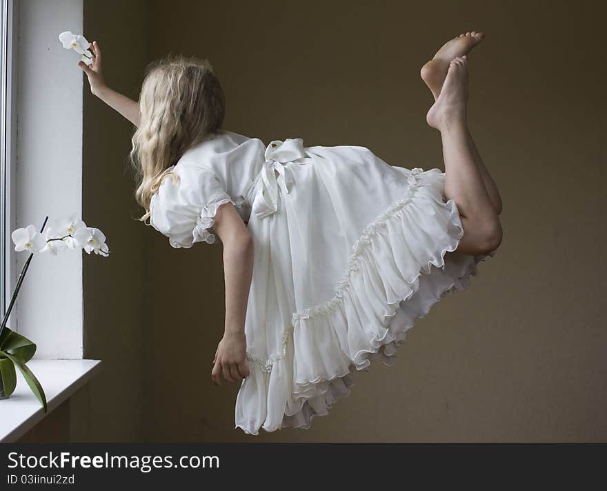 A young girl flying in the air. A young girl flying in the air