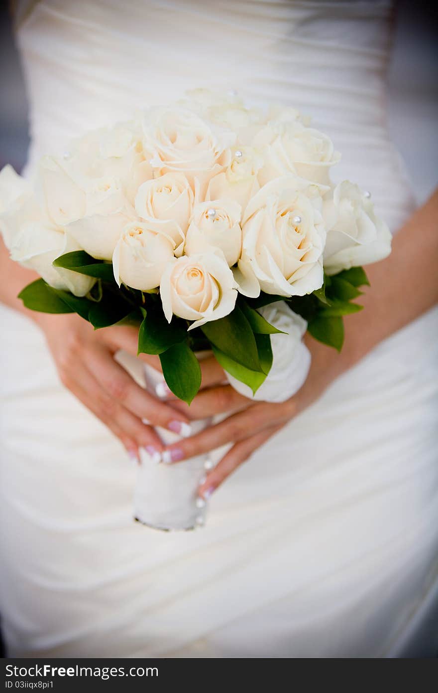 A close up of a bride holding a bouquet