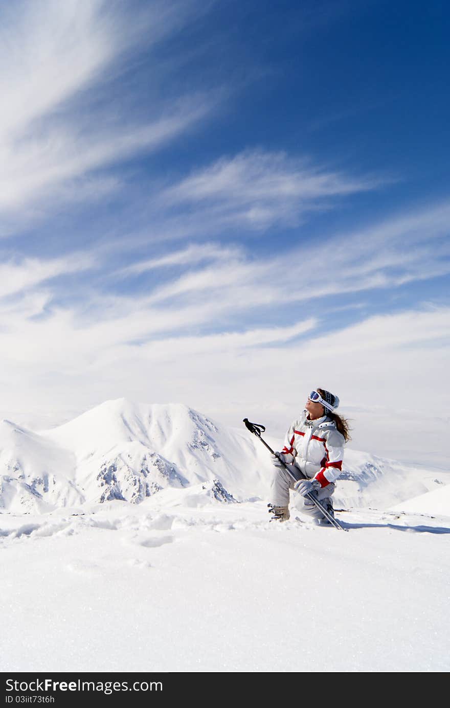 Beautiful skier on the top of mountain Ejder looking at the sky