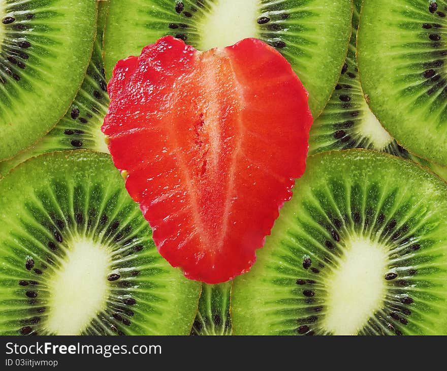 Strawberry in a kind heart against kiwi. Red and green. Strawberry in a kind heart against kiwi. Red and green.