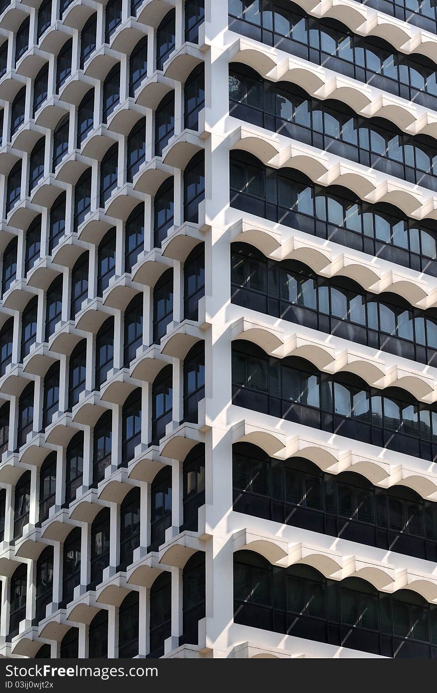 Modern building in Hongkong, with repeated small vaulted in white and deep blue color, shown as modern architecture feature or background pattern. Modern building in Hongkong, with repeated small vaulted in white and deep blue color, shown as modern architecture feature or background pattern.