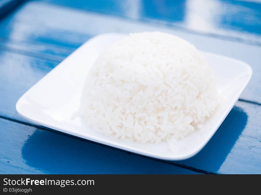 Thai rice on plate in blue background, Close up shot.