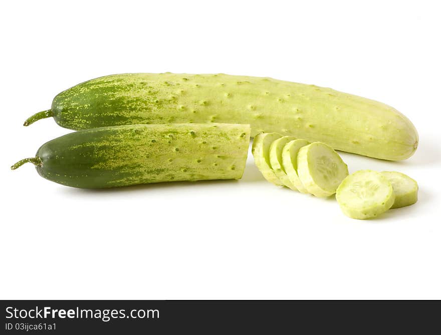 Two cucumbers, one whole, one partially sliced. Two cucumbers, one whole, one partially sliced