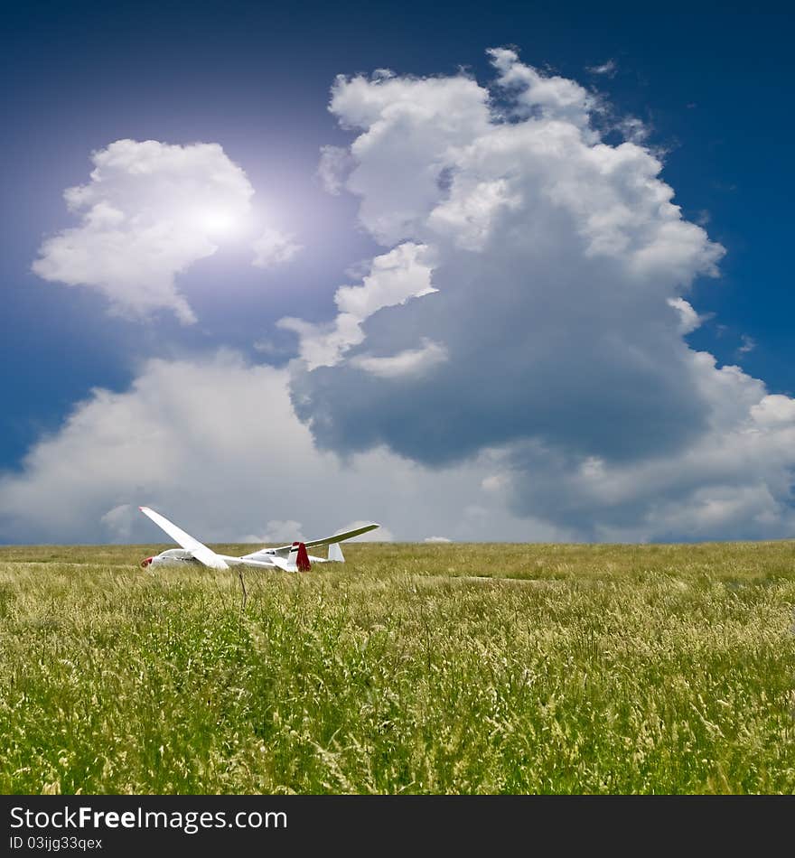 Two gliders on a small airfield with cloudy sky