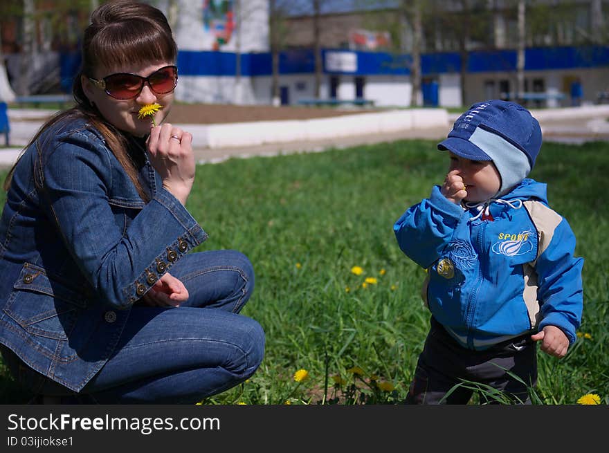 Photo of the Mother and son through dandelions