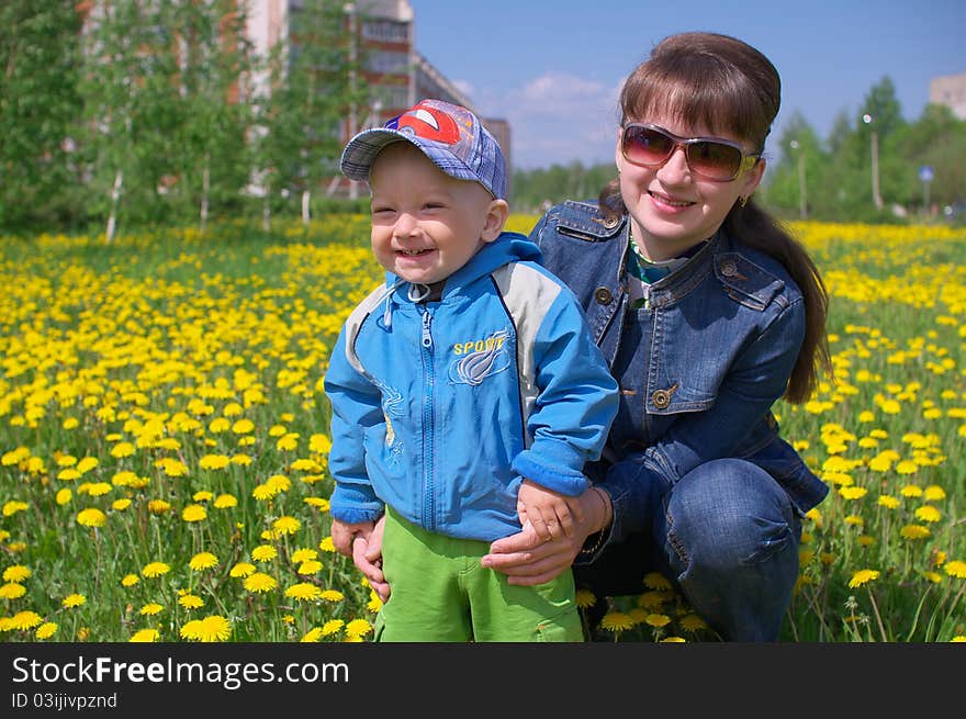 Photo of the Mother and son through dandelions