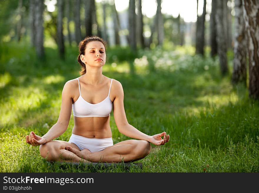 Practicing of yoga outdoors.