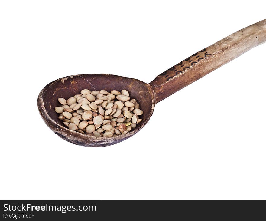 Wood spoon with lentils isolated