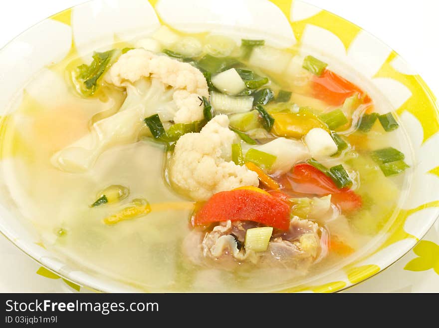 Soup of different young vegetables in a dish. Soup of different young vegetables in a dish