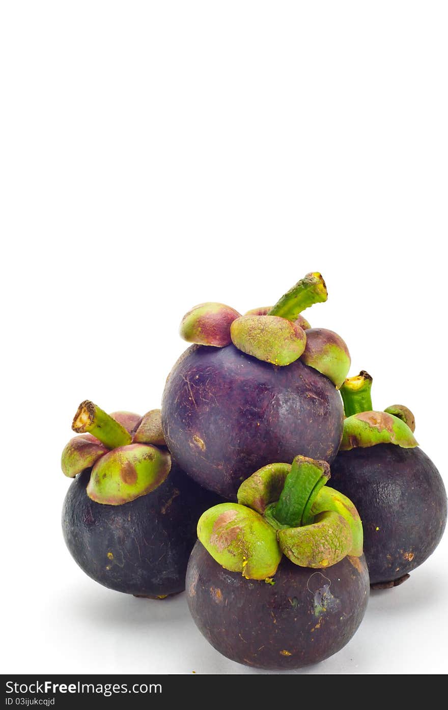 Mangosteen is a tropical fruit in white background