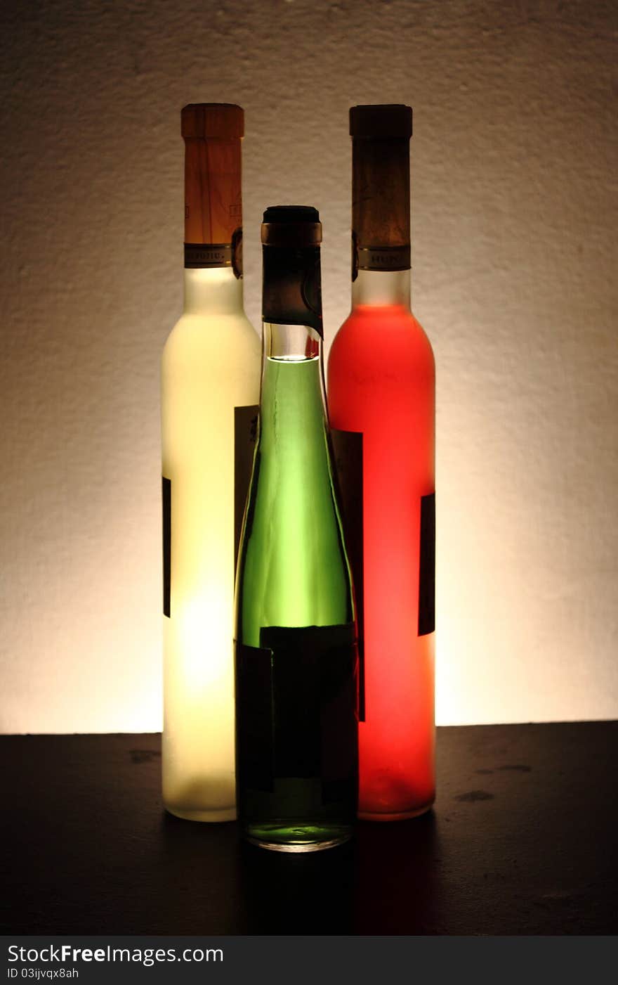 Three bottles of wine in three colors