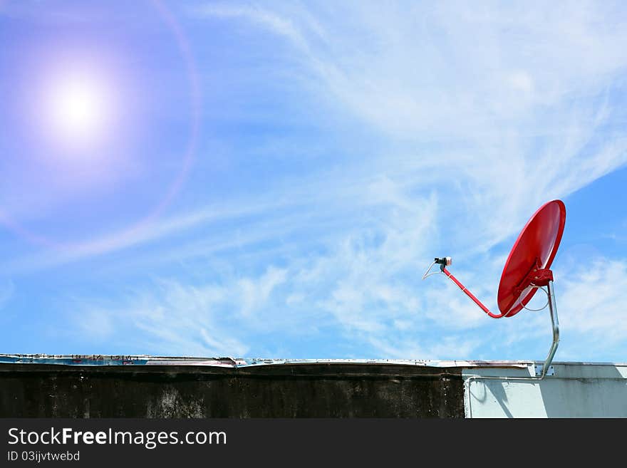 Isolated red satellite on sunny blue sky. Isolated red satellite on sunny blue sky