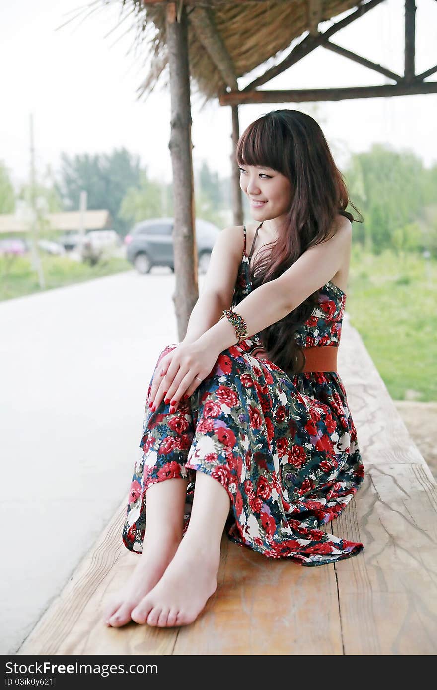 Chinese summer girl enjoying the scenery in the suburb. Chinese summer girl enjoying the scenery in the suburb.