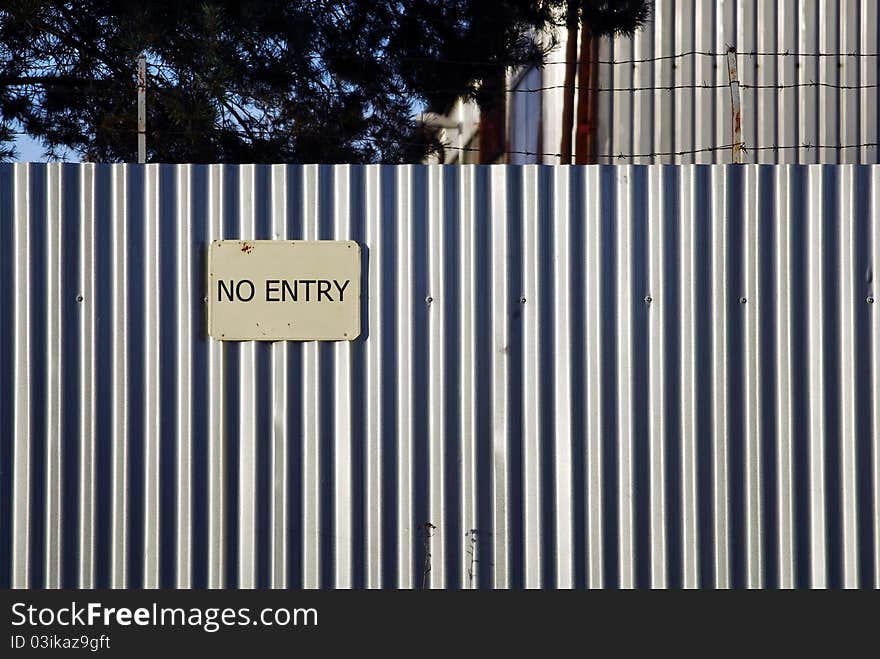 Barbed wire on the metal wall