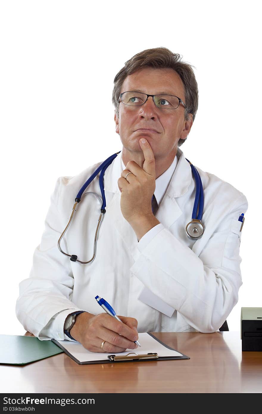 Thoughtful aged male doctor at desk