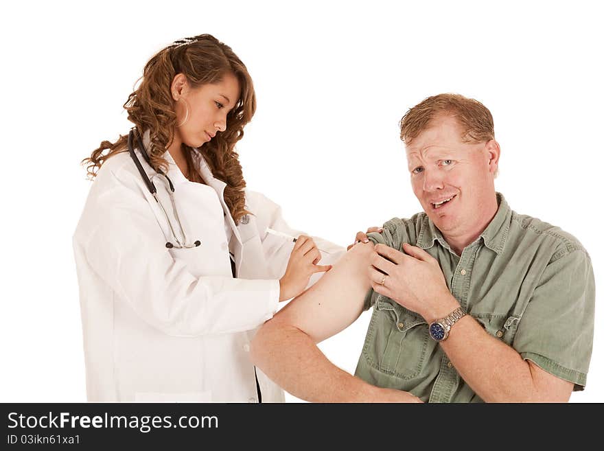 A doctor giving her paitent a shot in the arm, the patient is about to cry. A doctor giving her paitent a shot in the arm, the patient is about to cry.