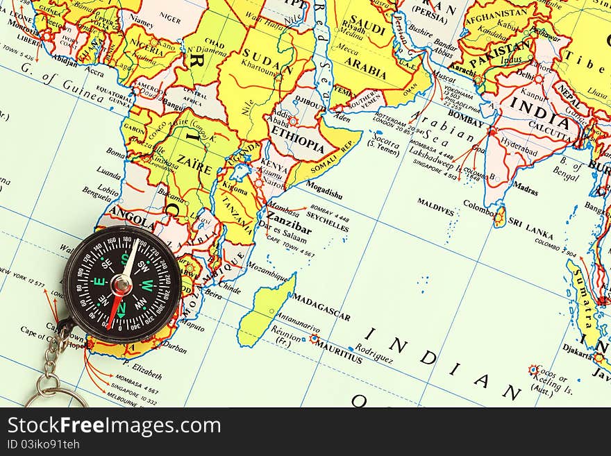 A compass is locate on world map. A compass is locate on world map