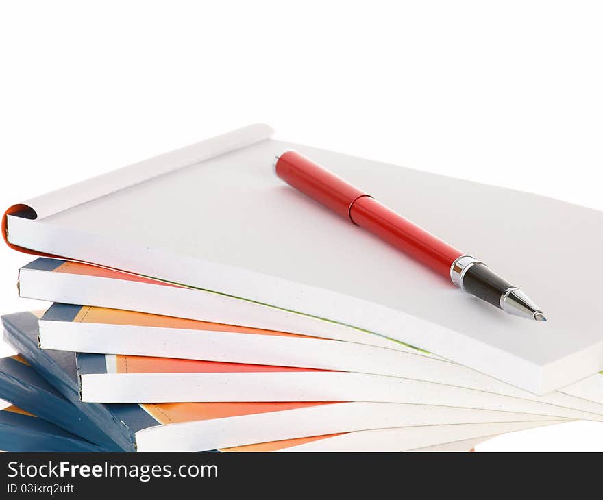 Red pen lays on notebook stack takes notes. Red pen lays on notebook stack takes notes