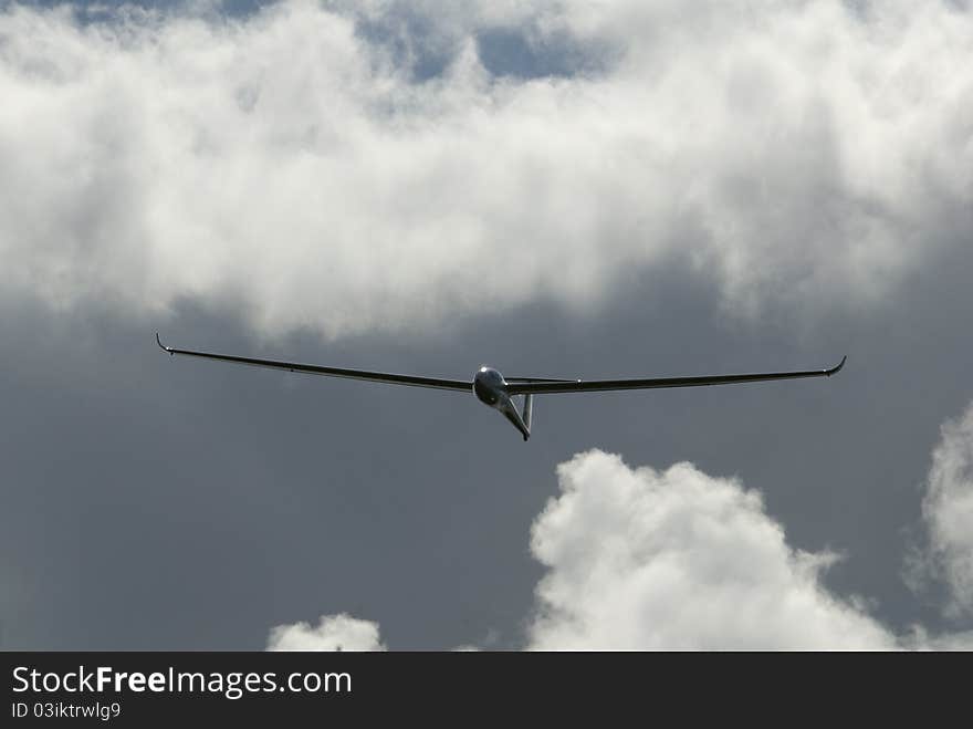 Glider flight with moody backdrop of clouds. Glider flight with moody backdrop of clouds.