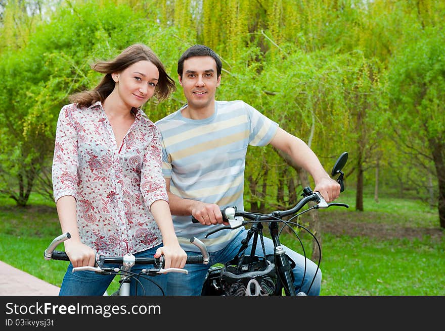 Happy young couple riding bicycles