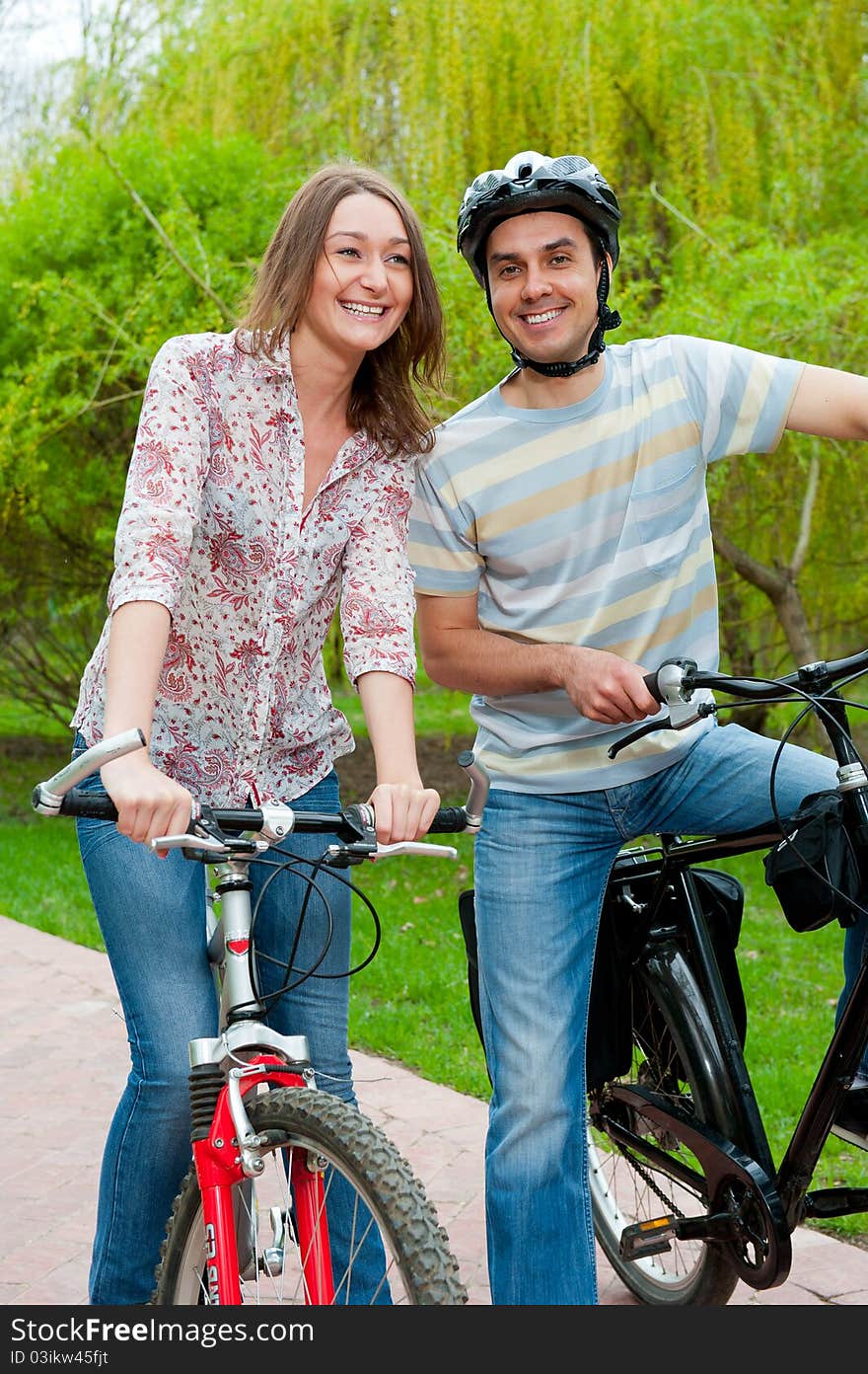 Happy Young Couple Riding Bicycles