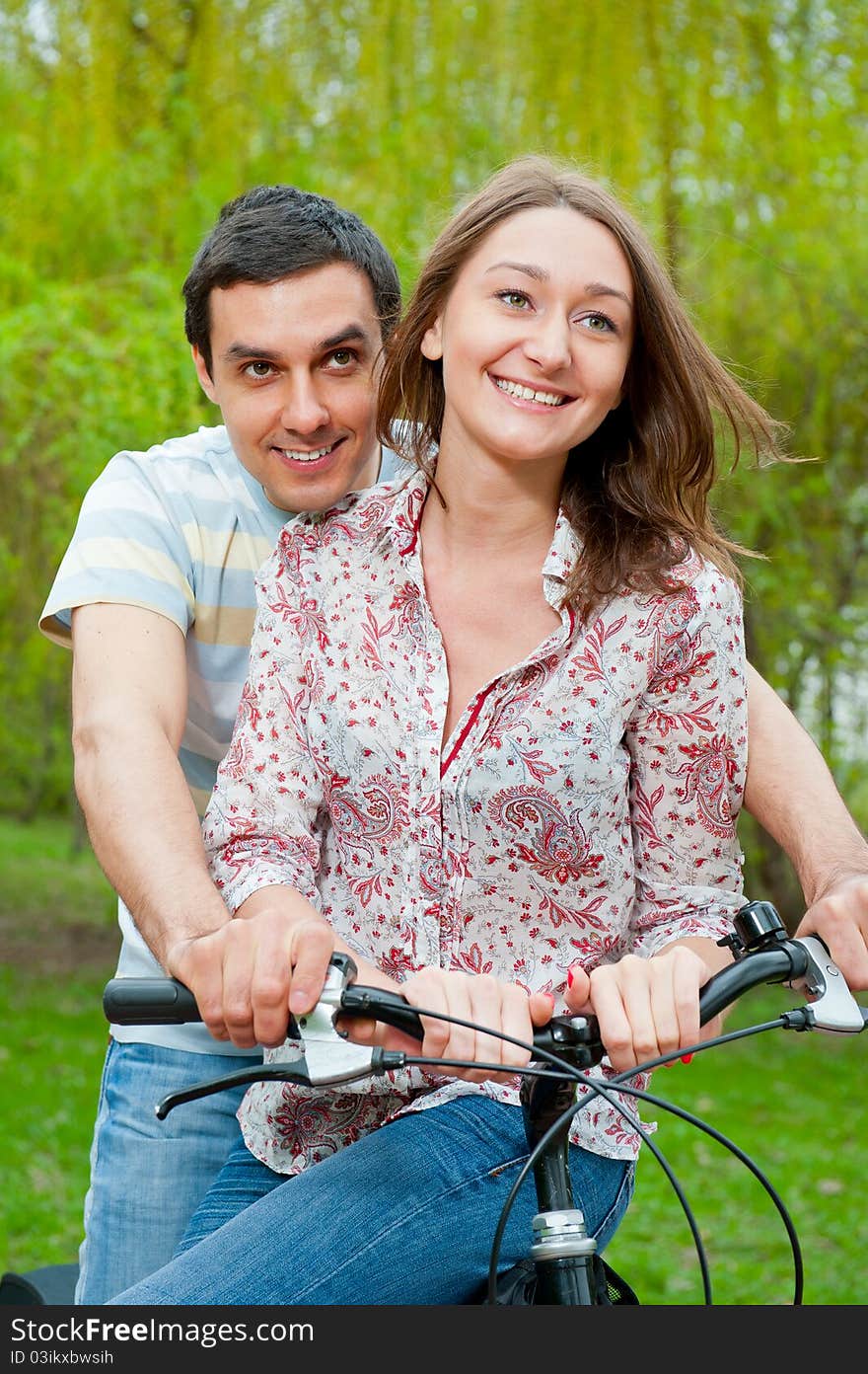 Happy Young Couple Riding Bicycles