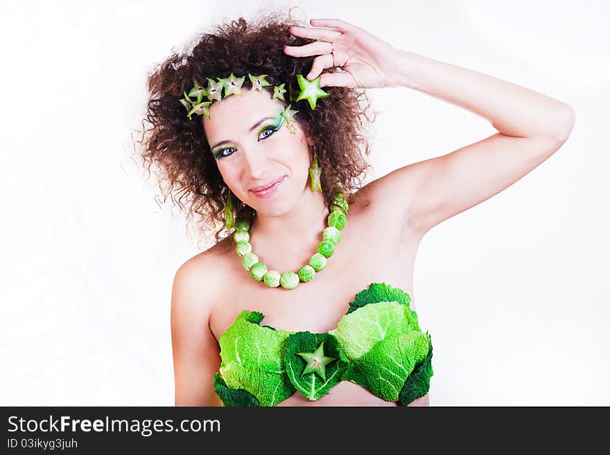 Beautiful pregnant young woman dressed in cabbage isolated on white