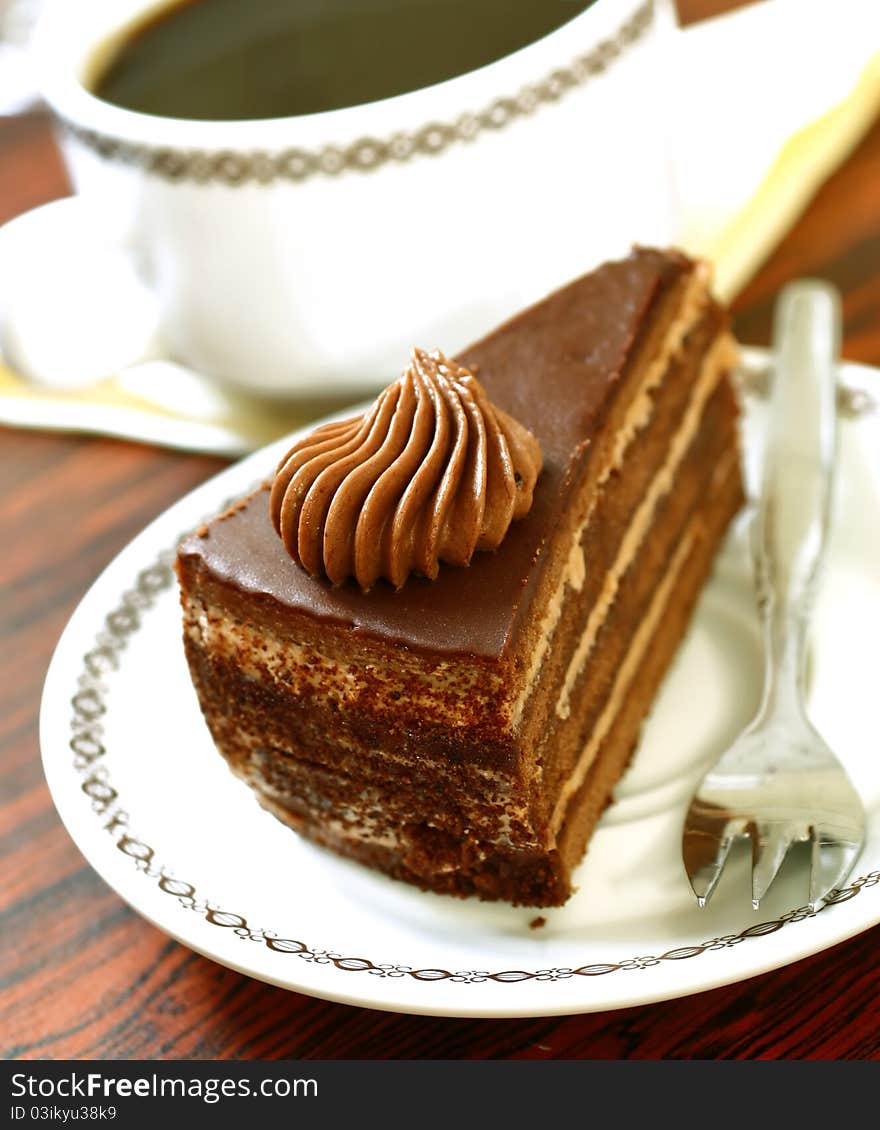 Chocolate cake on plate and cup