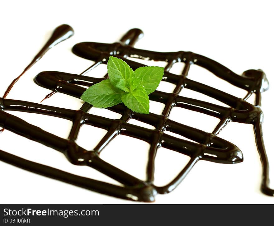 Chocolate Syrup And Leaf Of Mint Isolated On White