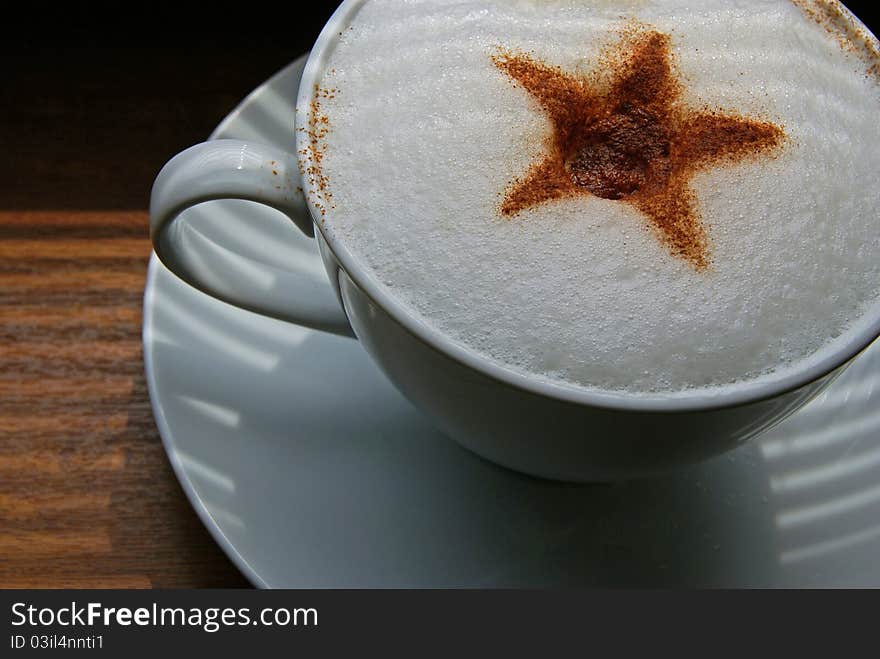 Close up of coffee cup with ornament made of cinnamon. Close up of coffee cup with ornament made of cinnamon