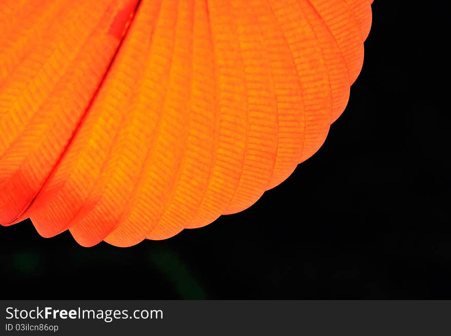 Chinese paper lantern in illuminating orange light at night