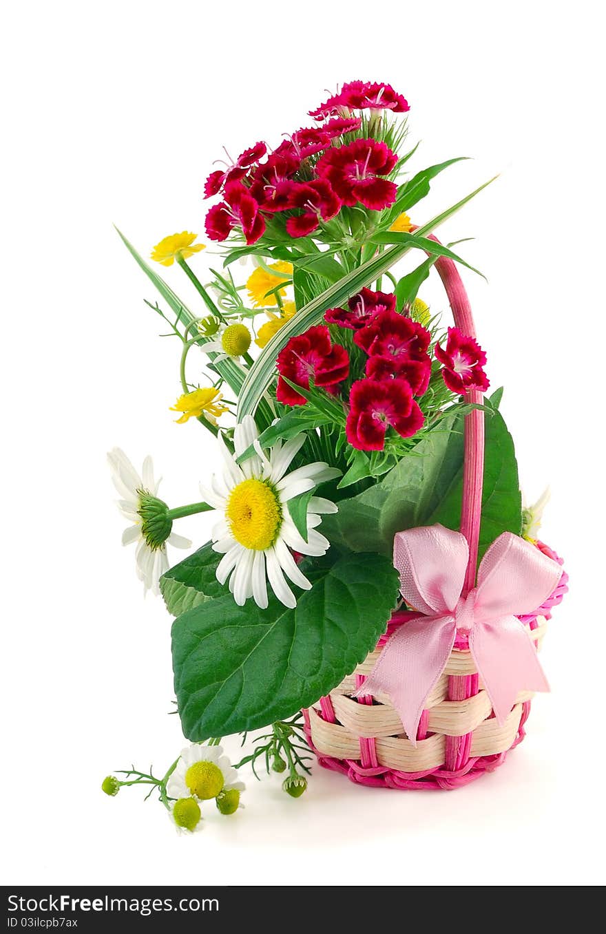 The wattled basket from a rod with natural flowers is isolated on a white background