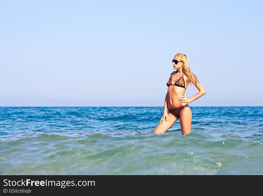 Beautiful woman standing in sea water. Beautiful woman standing in sea water