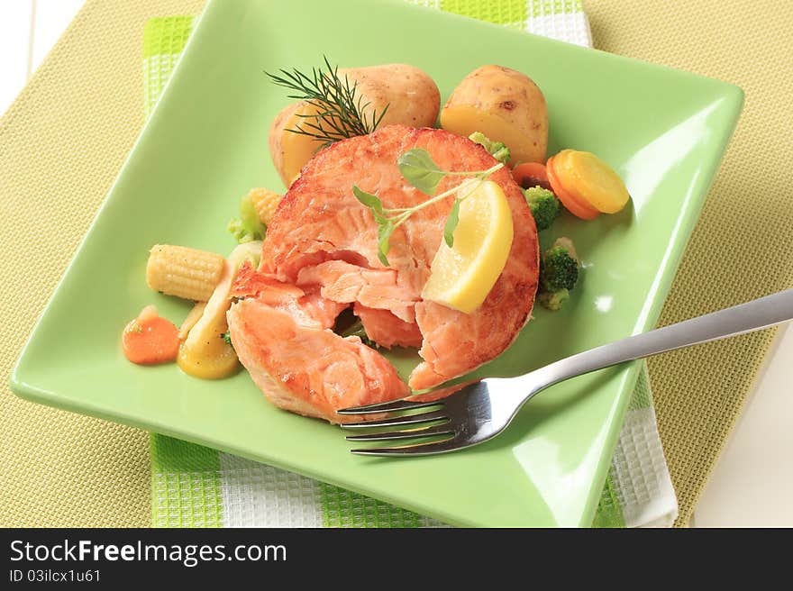 Salmon with potatoes and stir fried mixed vegetables. Salmon with potatoes and stir fried mixed vegetables