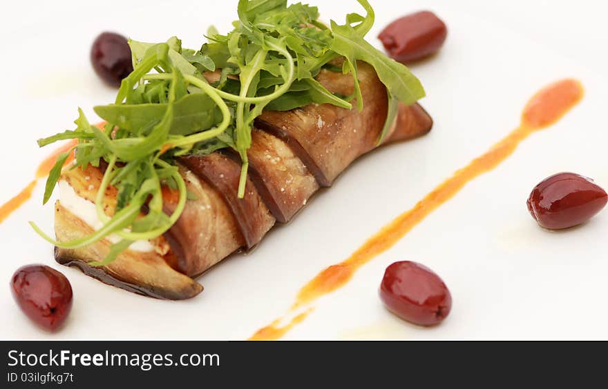 Feta cheese wrapped in eggplant with Kalamata olives and dip strawberry salad with arugula