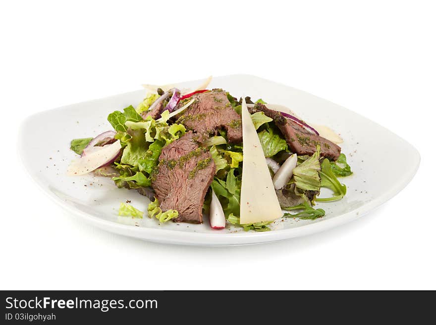 Green salad with meat and cheese on white palte isolated on white background