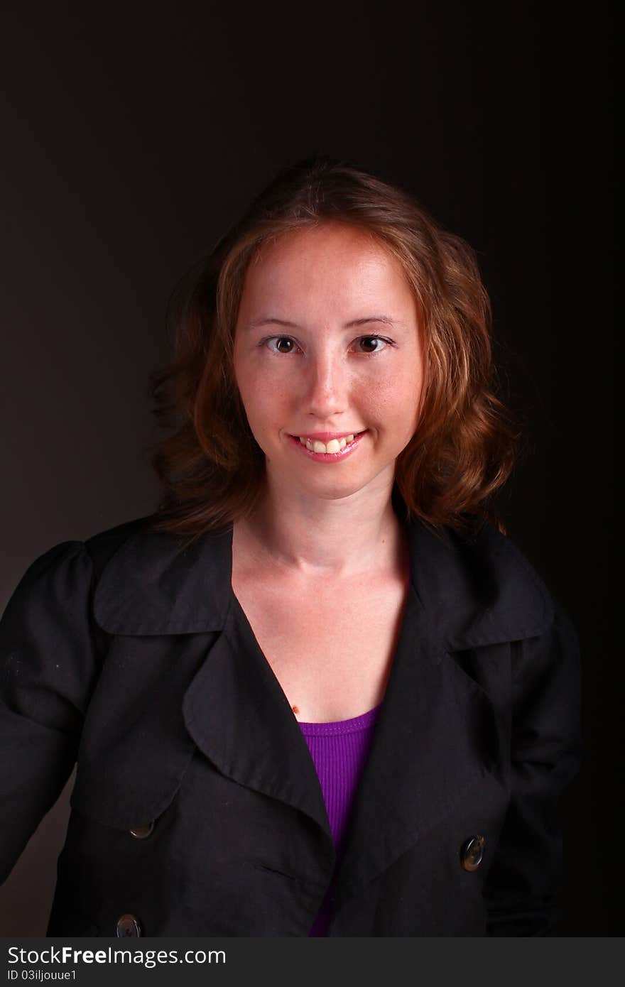 Business woman in serious and formal dress. Portrait on a dark background. Business woman in serious and formal dress. Portrait on a dark background.