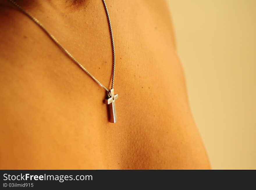 A black, african-american, latina, ethnic, woman proudly wears her silver cross necklace. A black, african-american, latina, ethnic, woman proudly wears her silver cross necklace.