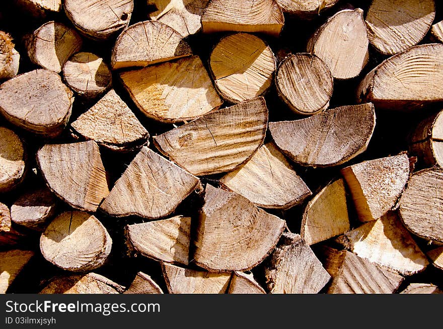 Fragment of choppen firewood. Wooden texture background .