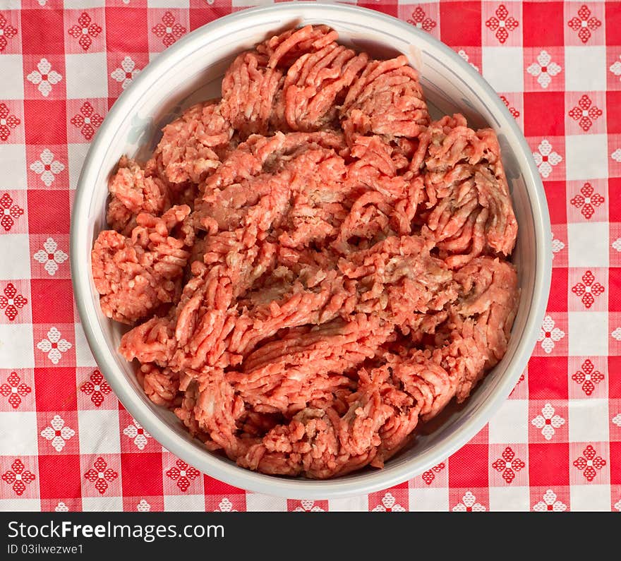 A bowl of uncooked ground beef in preparation of a meal