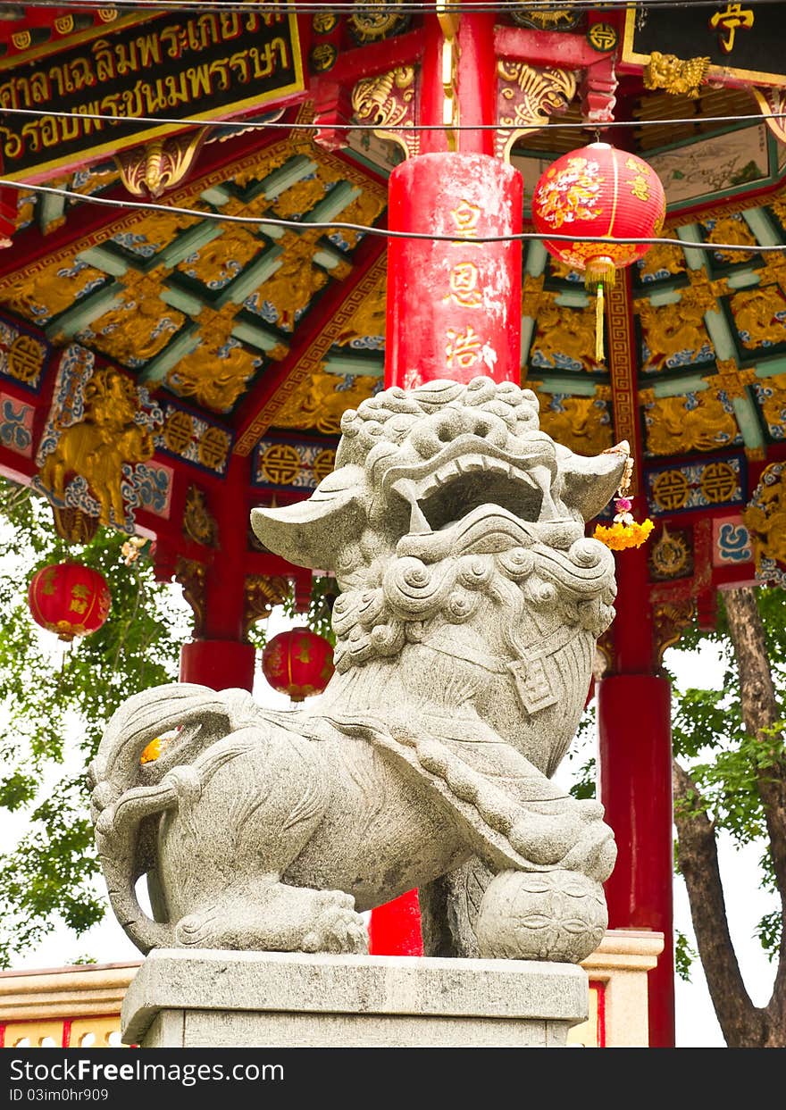 Stone lion and Chinese pavilion