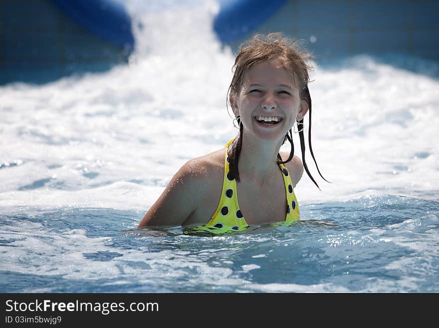 Happy girl with a big smile in a blue pool. Happy girl with a big smile in a blue pool