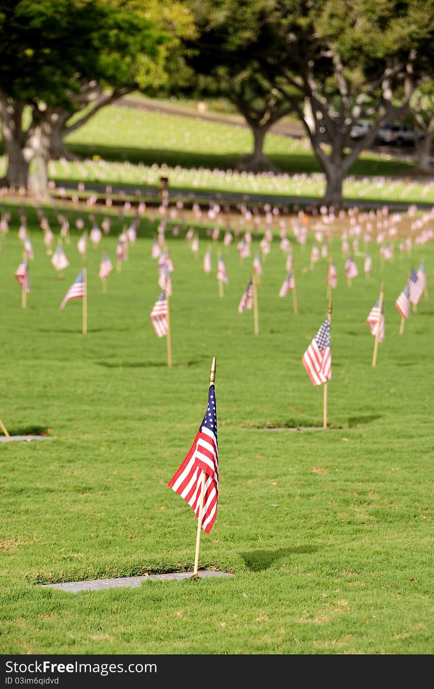 A row of flags at the grave sites on Memorial Day (2011) at the Punch Bowl National Cemetery on the Island of Oahu in Hawaii.