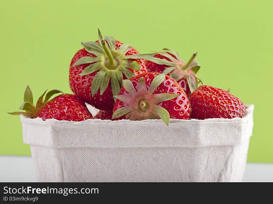 Studio-shot of a bowl with fresh organic ( bio) strawberries from the market. , with a green background. Studio-shot of a bowl with fresh organic ( bio) strawberries from the market. , with a green background.